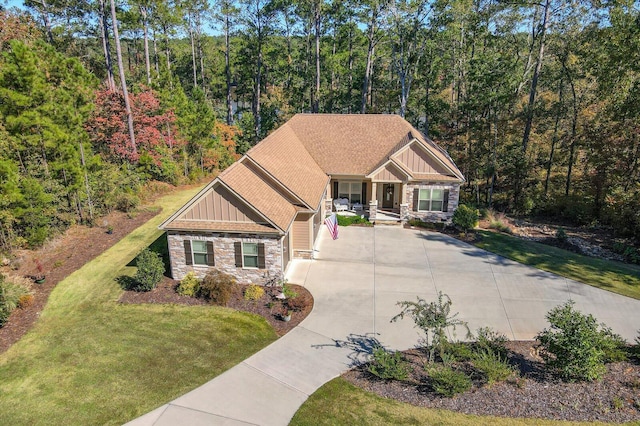 106 Bereau Dr, Mccormick, SC 29835 - craftsman-style house featuring board and batten siding, stone siding, driveway, a porch, and a front lawn