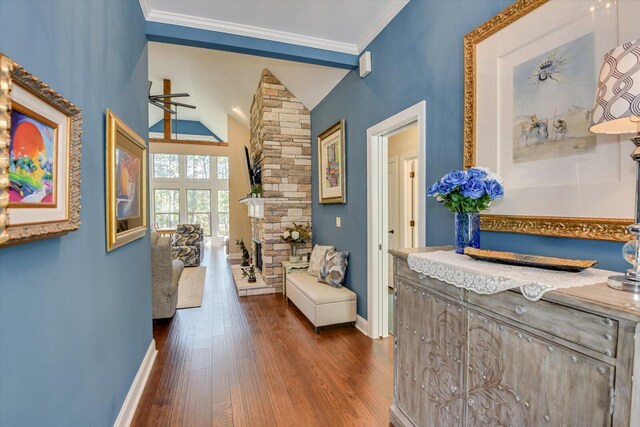 corridor featuring dark wood-type flooring, crown molding, and lofted ceiling