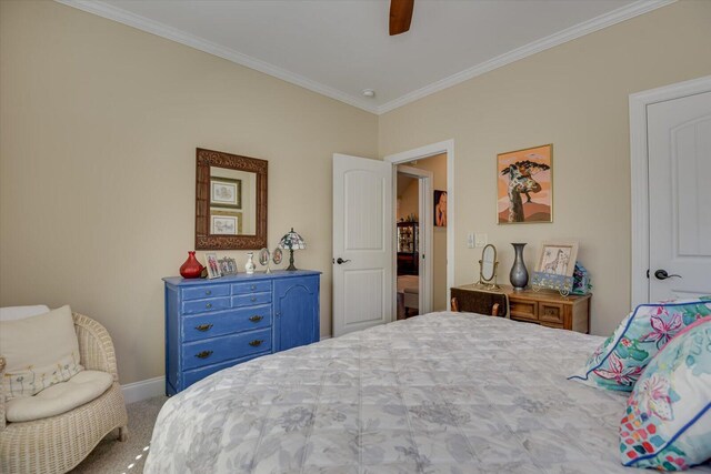 carpeted bedroom featuring ceiling fan and crown molding