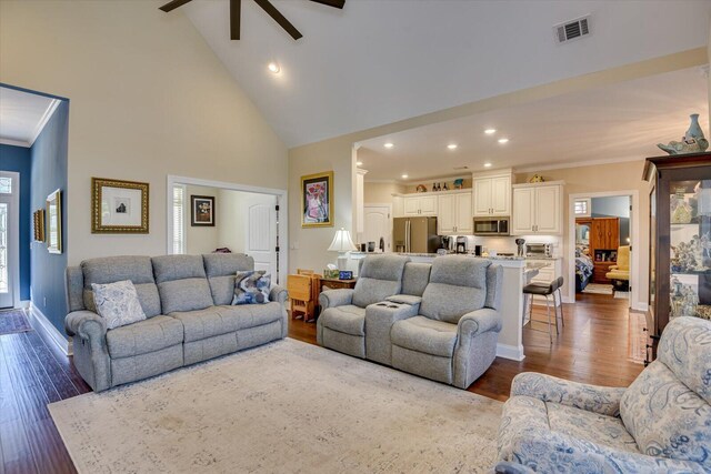 living room featuring ceiling fan, high vaulted ceiling, and dark wood-type flooring