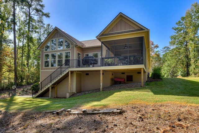 rear view of property with a sunroom and a yard