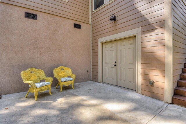 entrance to property featuring a patio