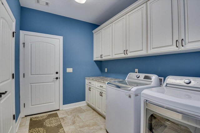 washroom with light tile patterned flooring, cabinets, and independent washer and dryer