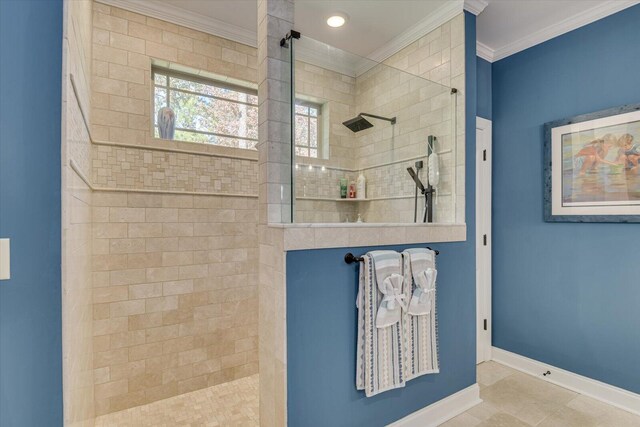 bathroom with a tile shower and crown molding