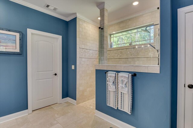 bathroom with tile patterned flooring and crown molding