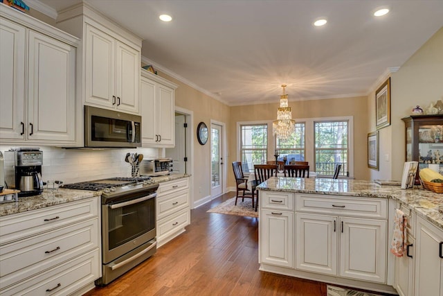 106 Bereau Dr, Mccormick, SC 29835 - kitchen with appliances with stainless steel finishes, recessed lighting, baseboards, light wood finished floors, and tasteful backsplash
