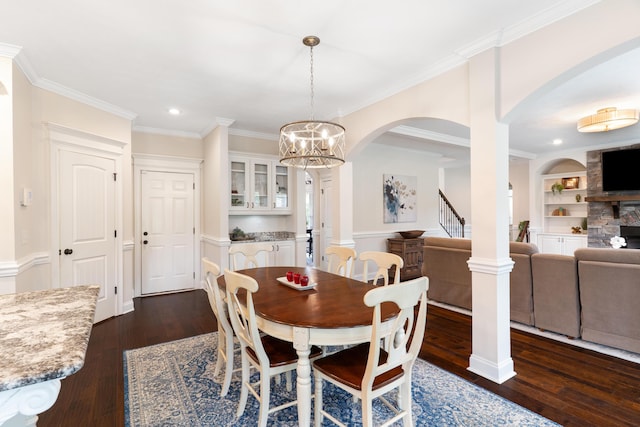 2224 Fothergill Dr, Evans, GA 30809 - dining area featuring arched walkways, dark wood-style flooring, a chandelier, ornamental molding, and recessed lighting