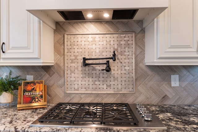 2224 Fothergill Dr, Evans, GA 30809 - kitchen with stainless steel gas cooktop, white cabinetry, backsplash, and light stone countertops