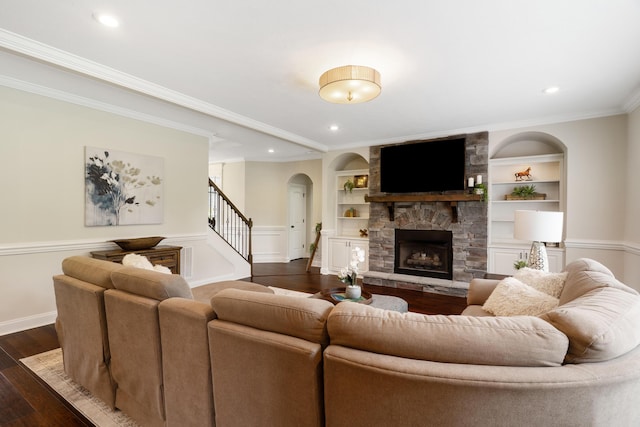 2224 Fothergill Dr, Evans, GA 30809 - living room featuring arched walkways, dark wood-type flooring, a stone fireplace, stairs, and built in shelves
