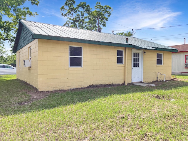 802 Yellow Town Rd, Waynesboro, GA 30830 - back of property with concrete block siding, a lawn, and metal roof