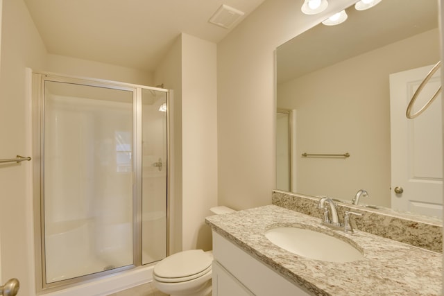 bathroom with vanity, toilet, and walk in shower