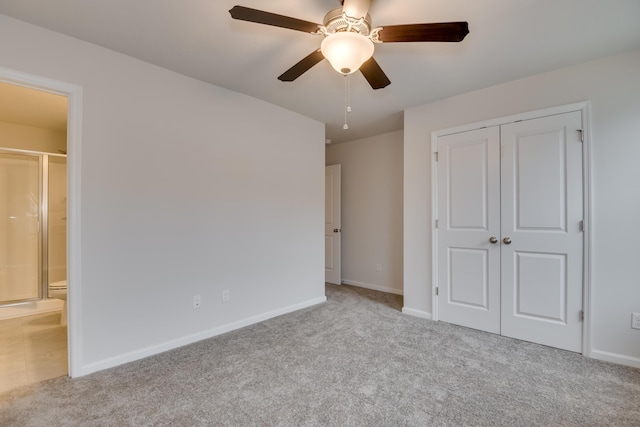 unfurnished bedroom with ceiling fan, light colored carpet, and a closet