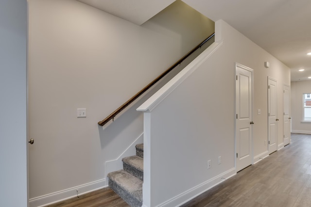 staircase with wood-type flooring