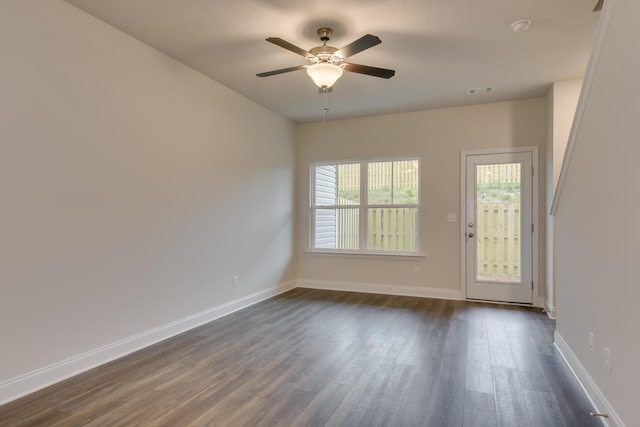 unfurnished room with ceiling fan and dark wood-type flooring