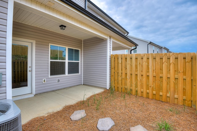 exterior space featuring central air condition unit and a patio