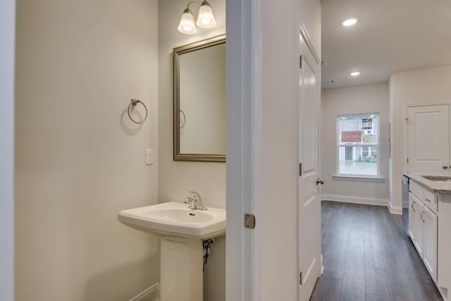 bathroom with hardwood / wood-style flooring and sink