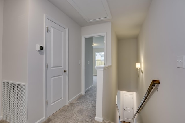 hall featuring light colored carpet