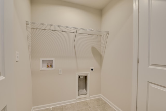 laundry room featuring washer hookup, electric dryer hookup, and light tile patterned floors