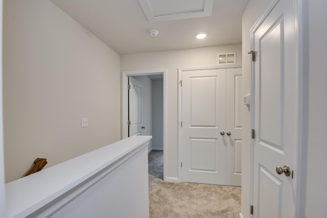 hallway with light colored carpet