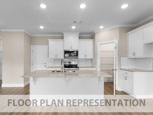 kitchen featuring visible vents, light stone countertops, an island with sink, appliances with stainless steel finishes, and white cabinetry