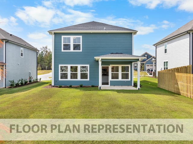 rear view of house featuring a patio, a lawn, a shingled roof, and fence