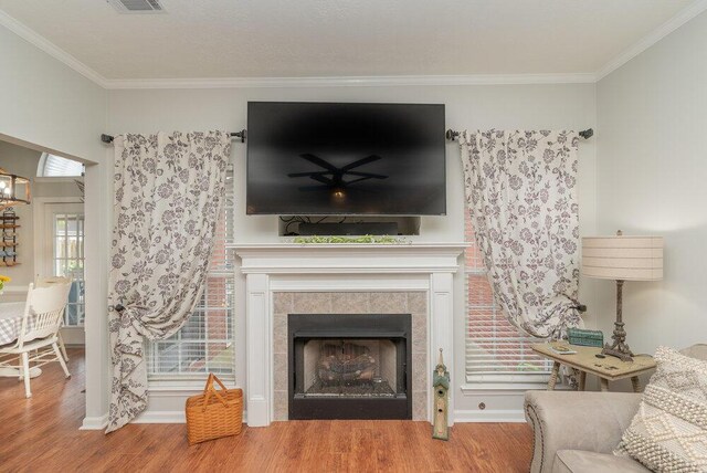 2108 Glenn Fls, Grovetown, GA 30813 - living room with wood finished floors, a tile fireplace, crown molding, and baseboards