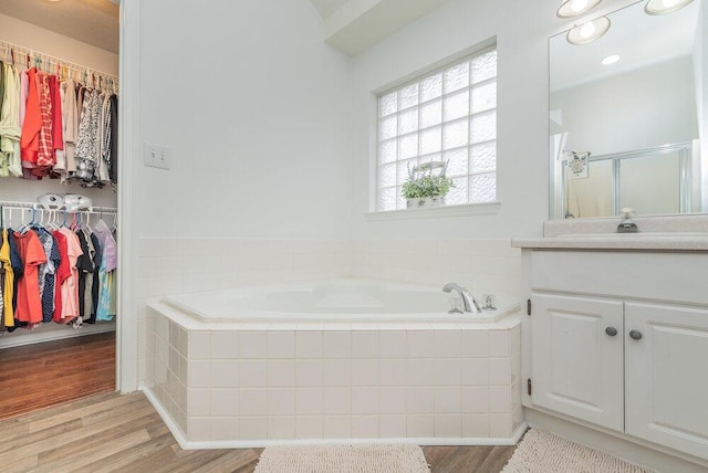 2108 Glenn Fls, Grovetown, GA 30813 - bathroom featuring a bath, vanity, wood finished floors, and a walk in closet