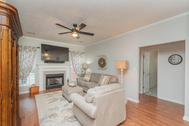 2108 Glenn Fls, Grovetown, GA 30813 - living room featuring a ceiling fan, wood finished floors, crown molding, a fireplace, and a textured ceiling
