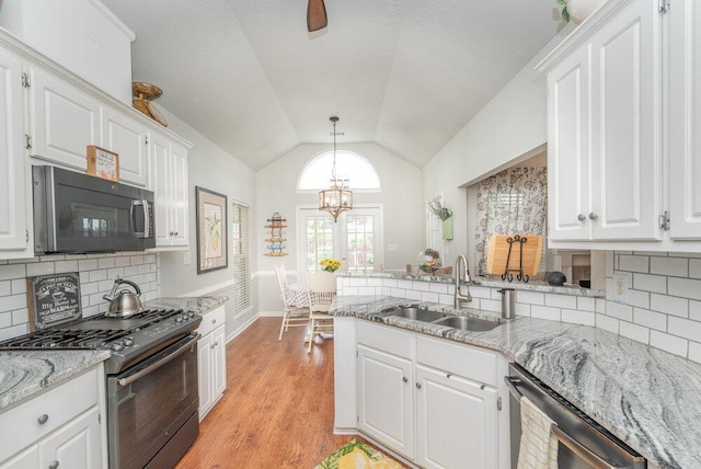 2108 Glenn Fls, Grovetown, GA 30813 - kitchen with stainless steel appliances, a sink, white cabinetry, lofted ceiling, and a peninsula