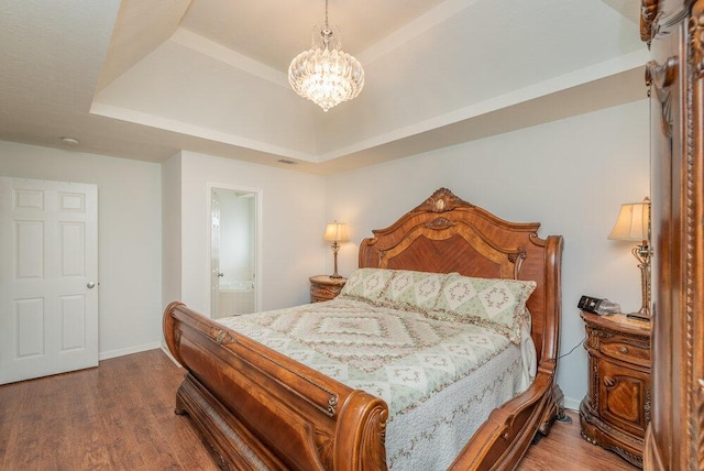2108 Glenn Fls, Grovetown, GA 30813 - bedroom featuring a tray ceiling, a chandelier, dark wood-style flooring, baseboards, and connected bathroom