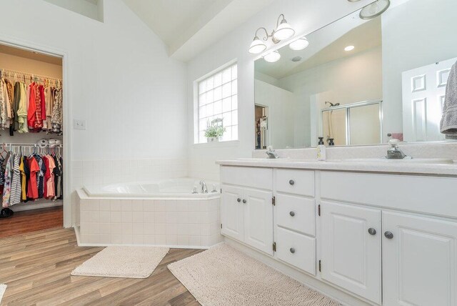 2108 Glenn Fls, Grovetown, GA 30813 - bathroom with a garden tub, double vanity, wood finished floors, vaulted ceiling, and a stall shower