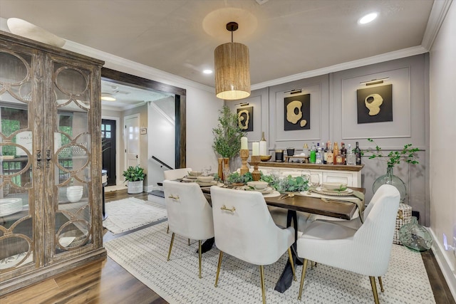 2206 Sandra Ct, Augusta, GA 30906 - dining area featuring wood finished floors, ornamental molding, a decorative wall, baseboards, and recessed lighting