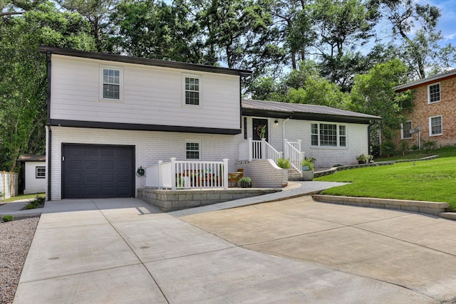 2206 Sandra Ct, Augusta, GA 30906 - tri-level home with a garage, brick siding, and driveway