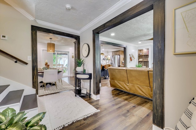 2206 Sandra Ct, Augusta, GA 30906 - entrance foyer with a textured ceiling, wood finished floors, stairs, crown molding, and baseboards