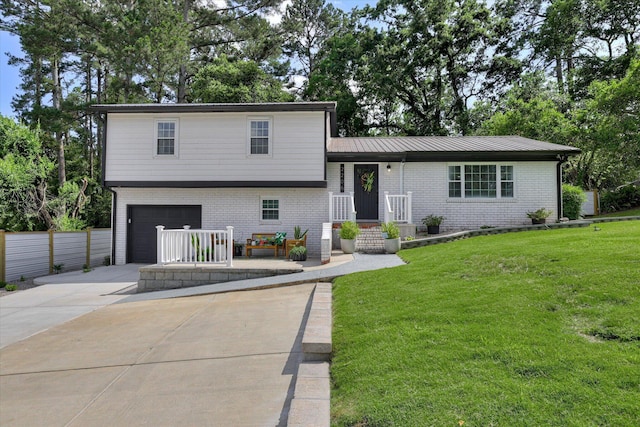 2206 Sandra Ct, Augusta, GA 30906 - tri-level home with an attached garage, driveway, and brick siding