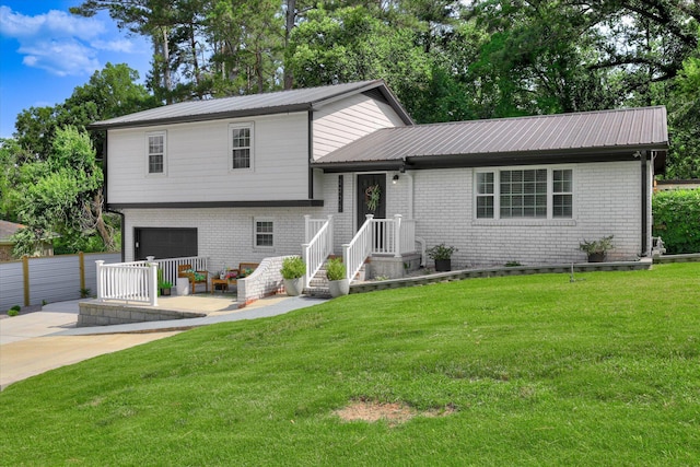2206 Sandra Ct, Augusta, GA 30906 - split level home featuring brick siding, metal roof, a garage, and driveway