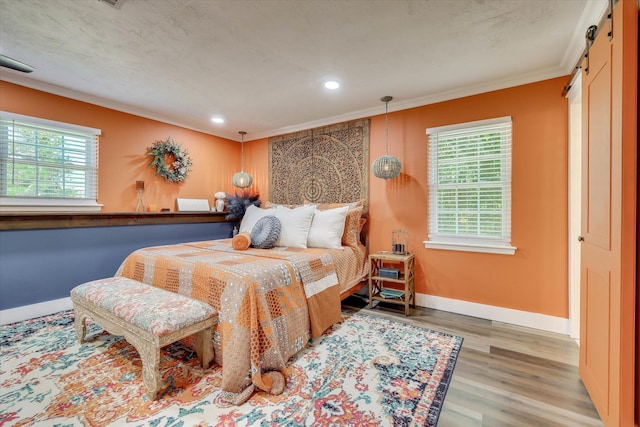 2206 Sandra Ct, Augusta, GA 30906 - bedroom with crown molding, wood finished floors, recessed lighting, baseboards, and a barn door