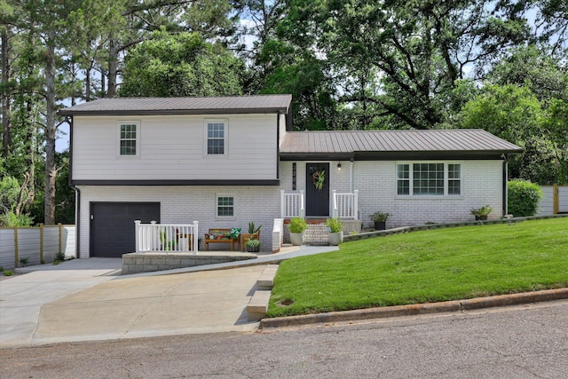 2206 Sandra Ct, Augusta, GA 30906 - tri-level home with a garage, driveway, brick siding, and metal roof