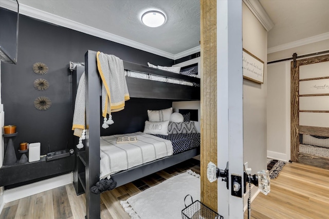 2206 Sandra Ct, Augusta, GA 30906 - bedroom featuring a barn door, ornamental molding, and wood finished floors