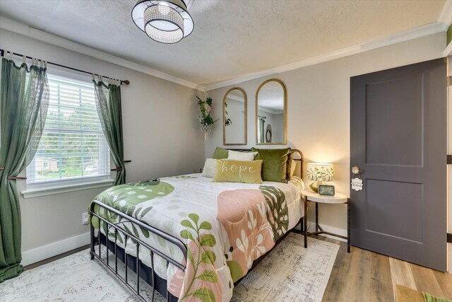 2206 Sandra Ct, Augusta, GA 30906 - bedroom featuring baseboards, ornamental molding, light wood-style floors, and multiple windows