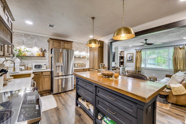 2206 Sandra Ct, Augusta, GA 30906 - kitchen with stainless steel fridge with ice dispenser, wooden counters, white microwave, wood finished floors, and ornamental molding