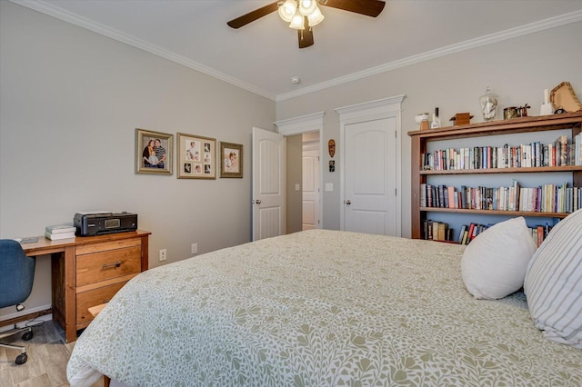 bedroom featuring ceiling fan, wood finished floors, and crown molding