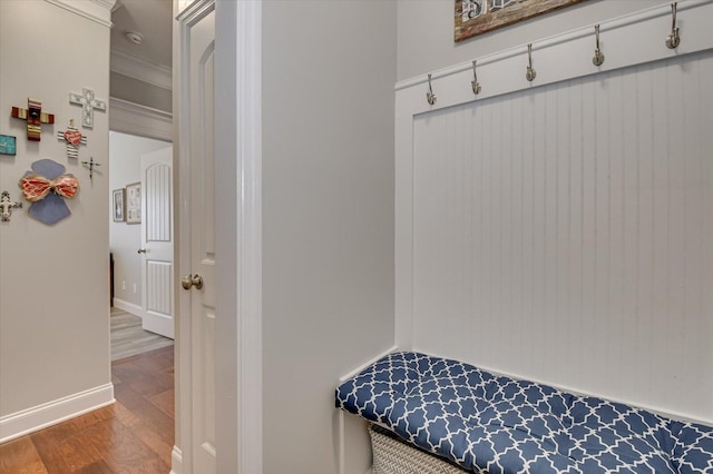 mudroom with baseboards, wood finished floors, and crown molding