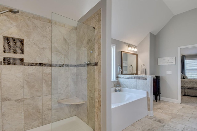 bathroom featuring a tile shower, a bath, ensuite bathroom, and vaulted ceiling