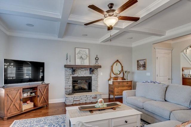 living room featuring beam ceiling, a stone fireplace, coffered ceiling, and wood finished floors