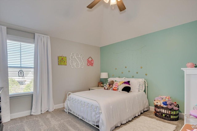 bedroom featuring light carpet, a ceiling fan, and baseboards