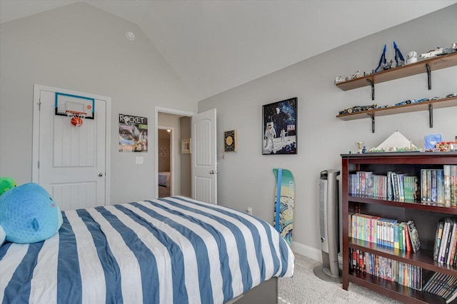 carpeted bedroom with baseboards and lofted ceiling