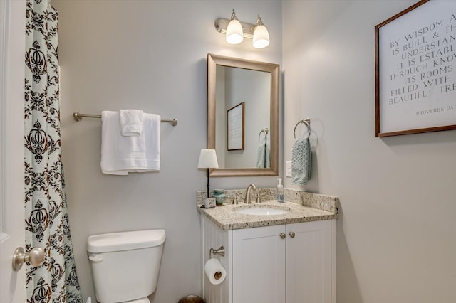 bathroom with toilet and vanity