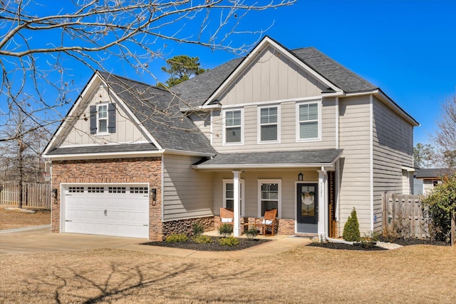 view of front of property with covered porch, board and batten siding, and fence