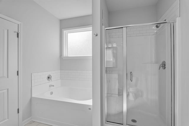 bathroom with separate shower and tub